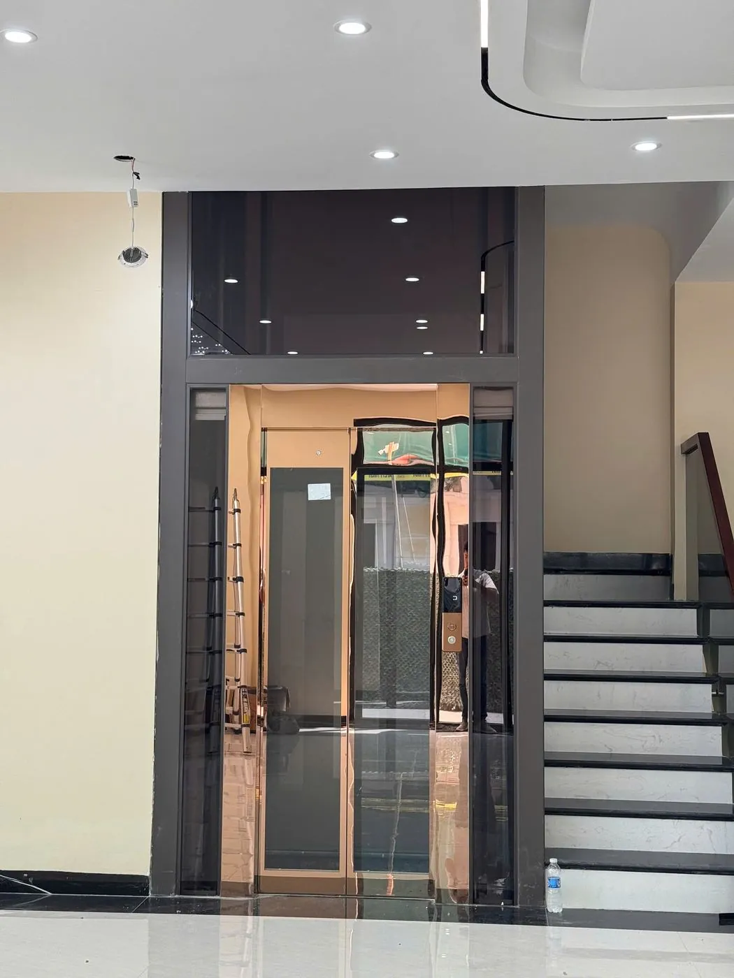 An elevator next to the stair core is a common layout in multi-storey townhouses